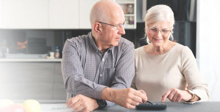 older couple looking at bills